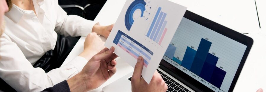 Two finance professionals reviewing transfer pricing analysis and benchmarking reports for an Indian subsidiary