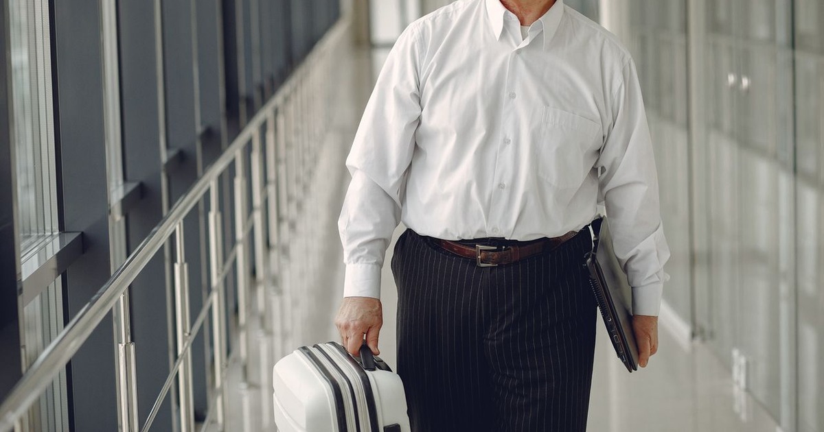 Business owner working on a laptop while travelling, representing NRI investment advisors in india